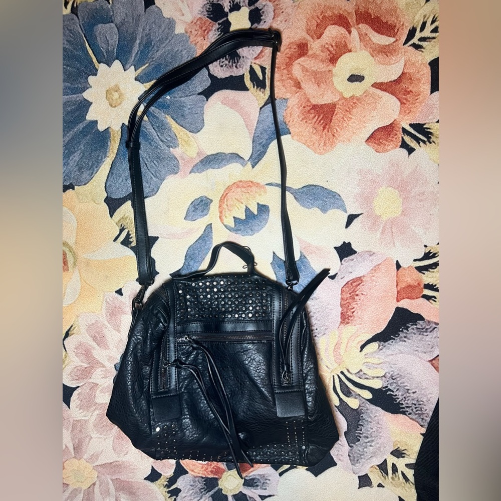 Black leather shoulder bag. Bag could also convert into a backpack